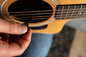 A closeup shot of a man's hand playing the guitar