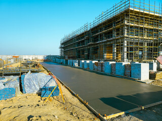 construction site with scaffolding and building materials, blue sky background