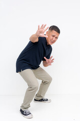 Full body photo of a cowardly asian man in fear pleading for mercy and gesturing stop with his...