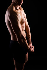 Fototapeta premium Image of muscle man posing in studio, dark white red background