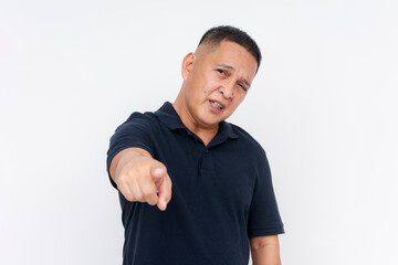 Middle-aged Asian man blaming someone pointing a finger blatantly, isolated on a white background. Making an accusation.