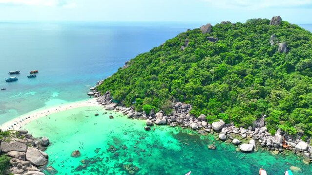 Explore paradisiacal isles linked by breathtaking sand strips, boasting unspoiled beaches, vibrant reefs, and crystalline waters. Flying from drone. High-quality video. Nangyuan island, Thailand. 4K.
