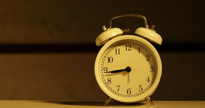Close-up shot of a vintage alarm clock as time passes by quickly. Stop at 12.00
