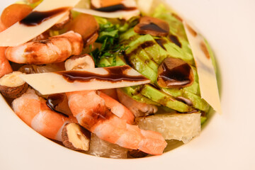 RECIPE FOR MIXED SALAD OF BOTTARGA AVOCADO SHRIMP CHINESE GRAPEFRUIT, SUCRINE SALAD, PARMESAN, HAZELNUT, BALSAMIC VINAIGRETTE. High quality photo
