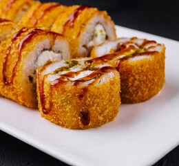 Warm tempura sushi rolls close up