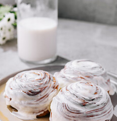 Tasty homemade vanilla cupcakes and bottle of milk