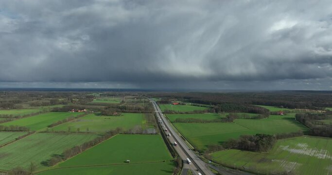 aerial footage of rainclouds moving away over the German E30 highway. Below you see Waldseite-Nord parking place.