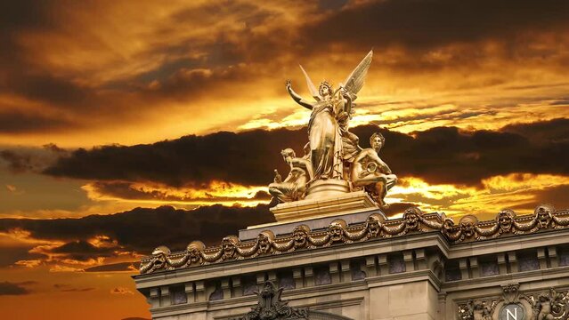 Golden statue of Liberty on the roof of the Opera Garnier (Garnier Palace)  against the background of the sunset. Sculpted by Charles Gumery in 1869. Paris, France. 4K, time lapse, with zoom 