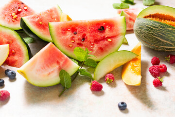 Different types of tasty ripe watermelon and melons with berry, close up.