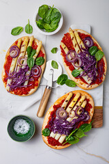 White asparagus, red cabbage, spinach flatbread or pizza