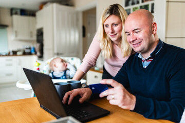 Family doing online shopping and having newborn baby
