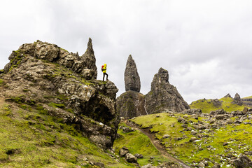 Man hiking in Scotland, Isle of Skye at the Old Man of Storr