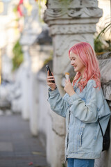 Woman using smartphone on the street.