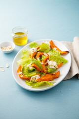Healthy salad with roasted pumpkin and almond