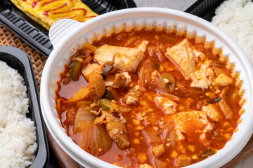 Korean food, kimchi stew, ham, soft tofu, pork, egg roll, rice, side dishes