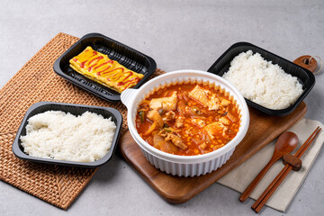 Korean food, kimchi stew, ham, soft tofu, pork, egg roll, rice, side dishes