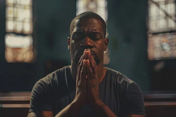 Fotobehang African American man praying in church. Cinematic effect © wolfhound911