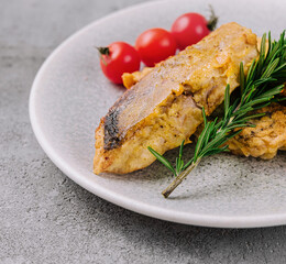 grilled fish steak and vegetables on a plate