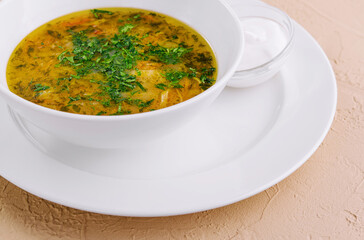 parsley noodle soup on white bowl