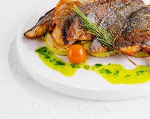 fried fish with vegetables on plate