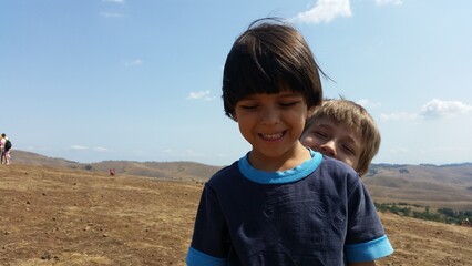 Happy kids, boys photo. Landscape mountain on the Sunny day.