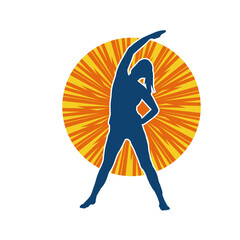 Silhouette of a slim sporty woman doing pilates exercise. Silhouette of a sporty female doing physical exercise. 