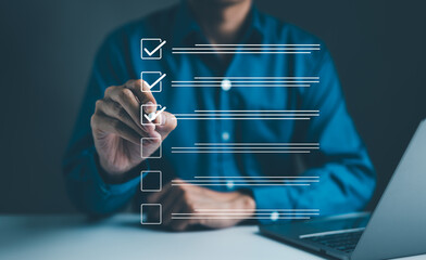 Businessman using pen to tick correct sign mark in checkbox for quality document control checklist and business approve project concept. Check mark, Filling out digital form checklist, Online exam,