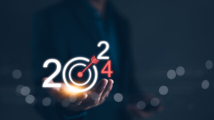 The 2024 new year business goals concept. Businessman hand show goals and targets for the company...