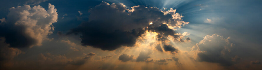 Panorama Beautiful light Sun shines behind the cumulus clouds.Colorful sunrise with Clouds over...