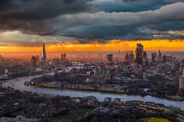 Moody weather view of the London skyline, with City and Tower Bridge, during rain and sunset