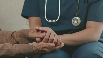 Female nurse doctor holding hands with senior grandmother patient Ready to give encouragement and advice. Close-up of an elderly woman's caregiver's hand