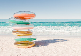 Fototapeta na wymiar stack of multicolored swim rings on a white sandy beach with ocean waves in the background. Fun and leisurely summer day.