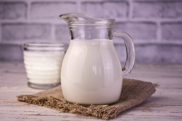 Milk in a glass decanter on the table.
