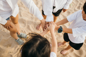 Team building at the beach. Family hands stack in a teamwork gesture representing success and unity. Nature meeting of parents and children conveying support motivation and connection