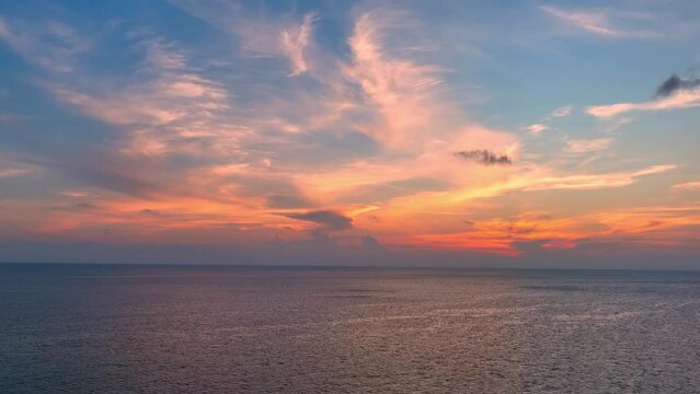 Capturing the boundless expanse of the sea under a golden sunset, a mesmerizing drone aerial view unfolds, endless horizons meeting tranquility. Flying from drone. Loop of sea background. 4K HDR.
