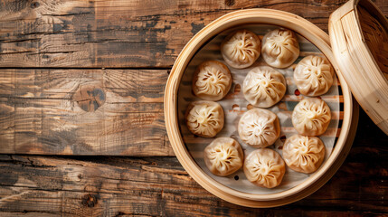 Obraz na płótnie Canvas Oriental dumplings with meat and broth lying in a bamboo steamer on a wooden table top view