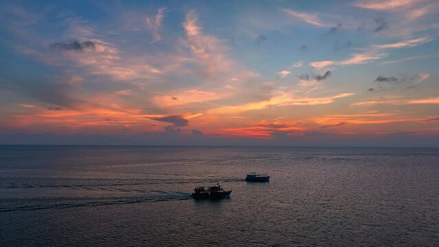 Surrender to the boundless beauty of the sea meeting the sky in a captivating drone aerial shot, capturing the tranquil sunset horizon. Nature stock footage. Bird's eye view. Sea background. 4K.
