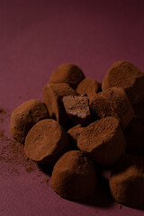truffle candies piled on a purple background