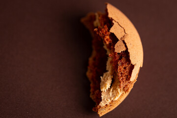 a piece of brown coffee macaroon on a brown background