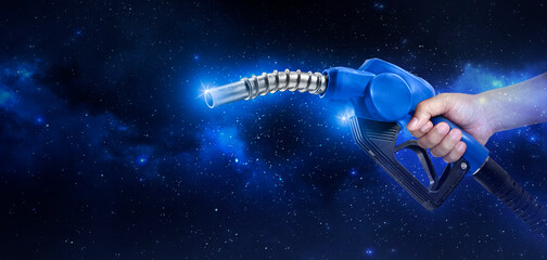Hands holding Fuel nozzle floating in the Planet view from space