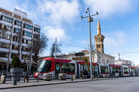 Low-angle view of a tram passing near EL Atik mosque in Setif city center, Algeria. Public transport. 