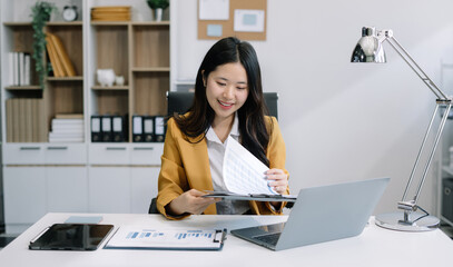 Business woman or financial data analysts working with smartphone and laptop computers and data graphs together. Plan to analyzing projects in the office.