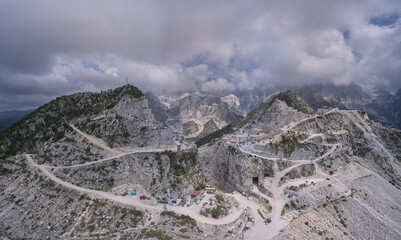 Aerial panorama of marble quarries Carrara Italy. Winding road to the marble quarry. Marble quarry...