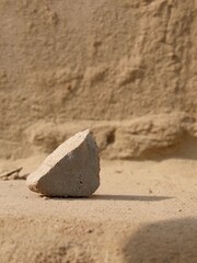 A close-up of a small stone, showcasing its texture and natural patterns.