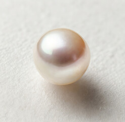 Nacreous single pearl isolated on white background - macro image