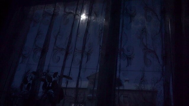 at night the moon shines in the window, a full moon shines through the window at night