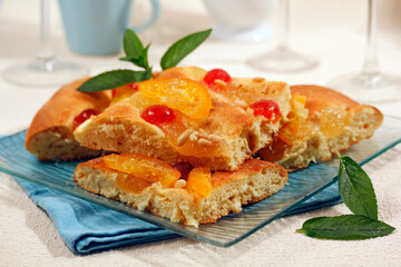 Cake with fruit, orange and pine nuts.