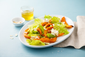 Healthy salad with roasted pumpkin and almond