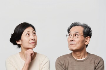 Fototapeta na wymiar 考えている日本人の初老の夫婦（白背景・老後・介護・健康・年金・将来）
