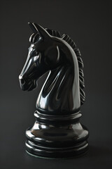 Sleek black knight chess piece on board, Vray tracing style, strategic gaming concept.